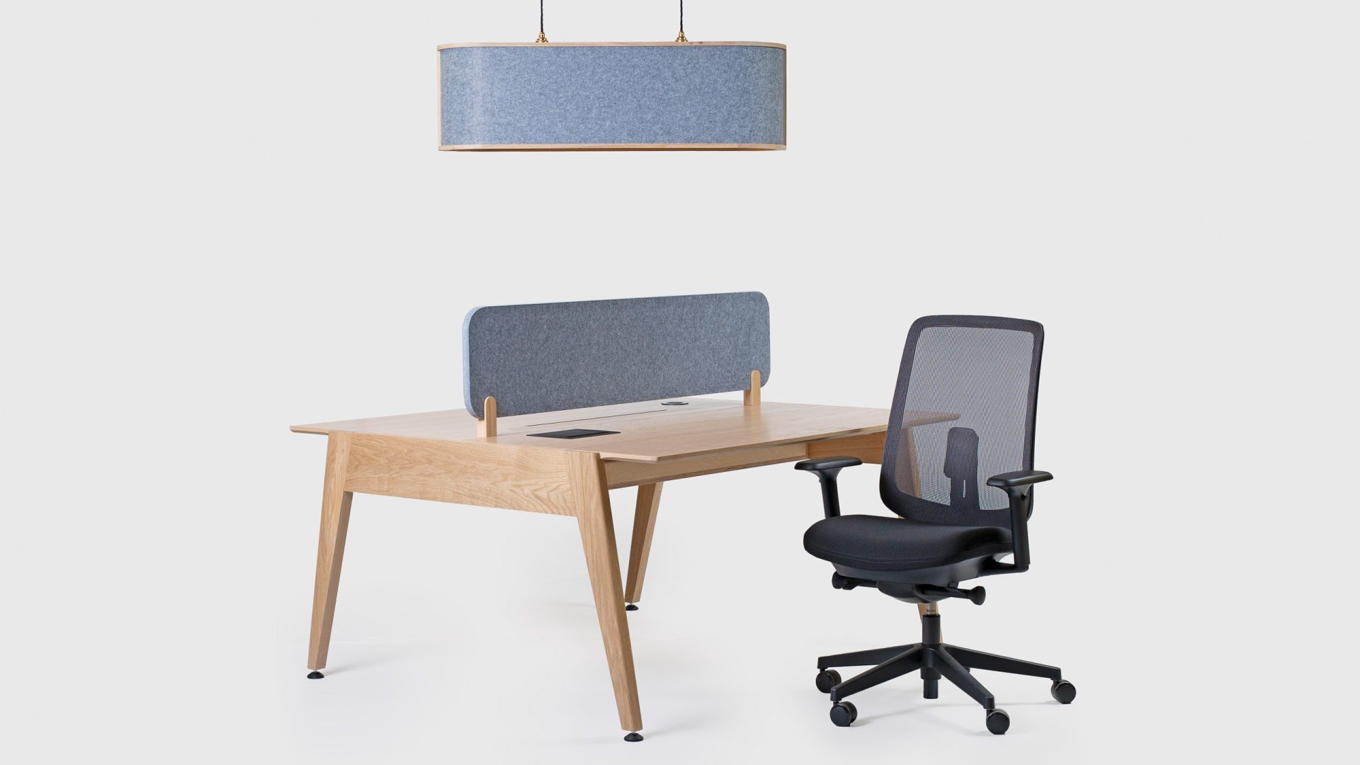 The Theodore Edge Office Desk – shown here with optional top divider and the Sonus Acoustic Pendant Light. All by Liqui Contracts.